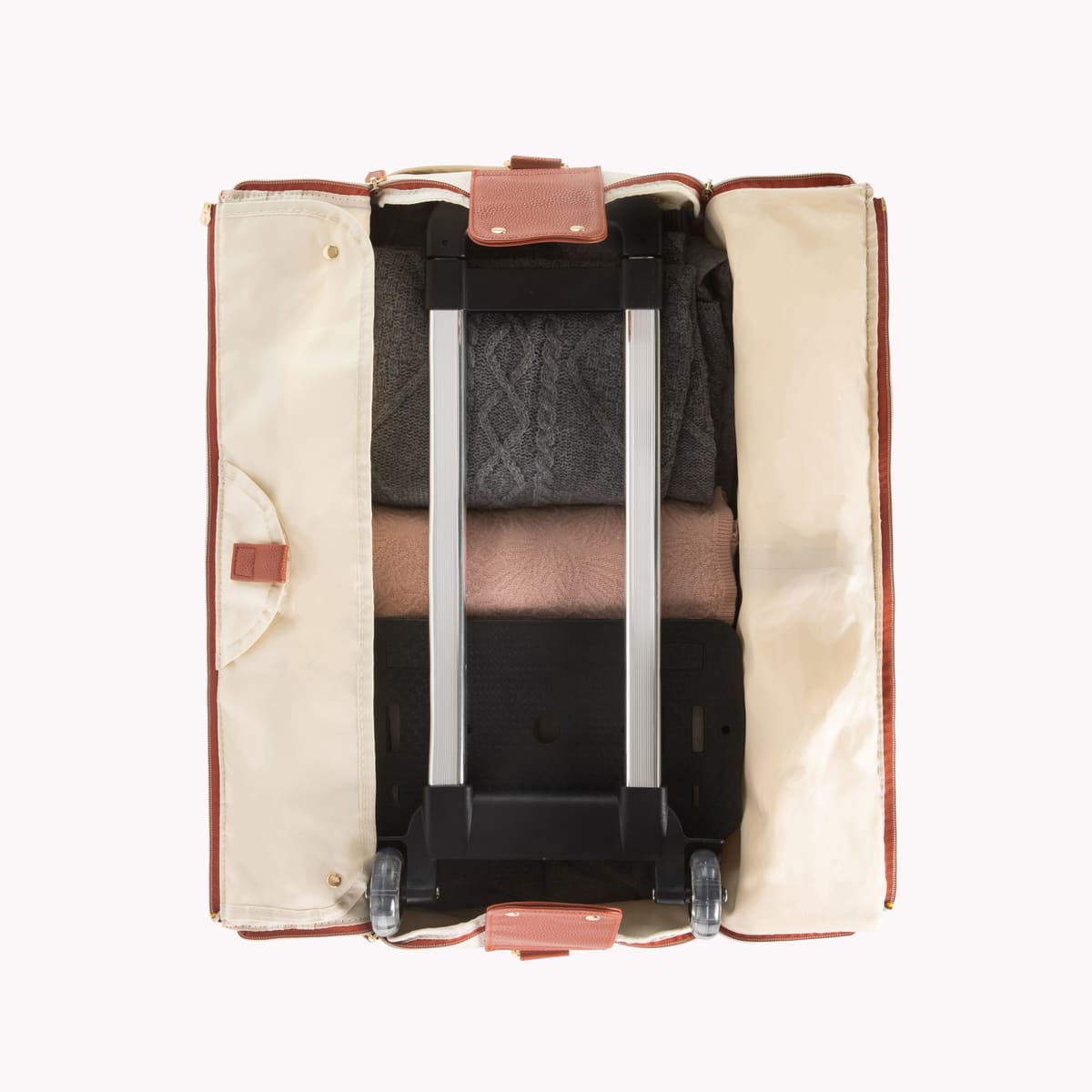 The open Luhxe bag with clothes packed flat in the lining and room in the main compartment